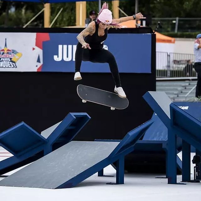 Leticia Bufoni in a black dress and shoes skating high.